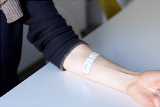 A woman wearing an armband on the forearm, monitoring dialysis